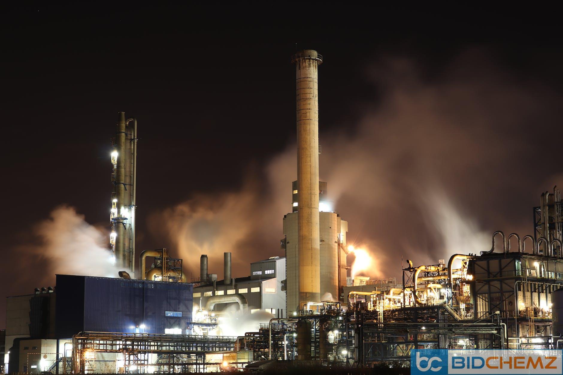 brown and white factory building during night time