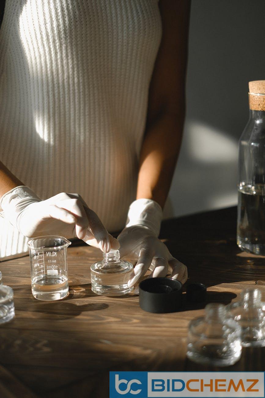 unrecognizable woman making liquid incense